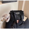 Detail of black pebble leather handbag with silver clasp and plush bunny charm - Black with Pendant