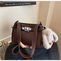 Detail of a brown leather crossbody bag featuring a silver twist lock and rabbit charm - Coffee (With Rabbit Charm)