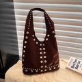 Sac hobo en daim marron foncé orné de clous argentés sur une couverture blanche - Marron