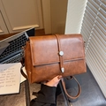 Vintage brown crossbody bag with square flap design and circular metallic clasp - Brown