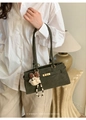 Detail of dark green retro handbag with golden lock and cute plush puppy charm - With Pendant / Green