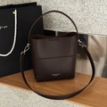 Detail of dark brown pebble leather bucket bag with silver hardware and shoulder strap - Ebony Coffee