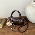 Detail of dark coffee leather cylinder bag with bear charm and silver bead chain - With Charm / Coffee