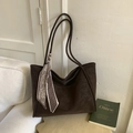 Detail of a dark coffee tote bag with a decorative paisley scarf in a minimalist setting - Brown