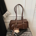 Detail of vintage brown oil wax leather shoulder bag with a cute plush bear charm on luggage - Coffee with Pendant