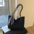 Macro detail of black suede tote bag with elegant silk scarf and slim shoulder straps - Black