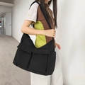 Black nylon messenger bag with multi-pocket design and wide shoulder strap in workwear style - Black