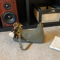 Olive green crescent shoulder bag in frosted faux leather with decorative metal charms - Green with Pendant