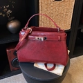 Chic dark red leather crossbody bag with silver rotating lock and shoulder strap - Burgundy