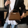 Dark brown patent leather handbag with metal turn-lock and top handle in trapezoid shape - Brown