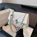 White quilted crossbody bag with silver chain strap shown in gift packaging box - White