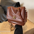 Vintage brown oil wax leather crossbody bag with decorative golden petal buckle detail - Brown