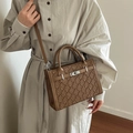 Brown textured Kelly handbag with geometric embossing and silver buckle closure - Brown