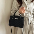 Classic black embossed leather handbag with metal buckle closure and top handle strap - Black
