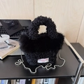 Detail of black sherpa handbag with faux fur trim, silver bead chain and white woven label - Black