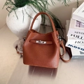 Brown lychee leather bucket handbag with silver twist lock and plush charm - Brown with Pendant