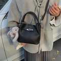 Black litchi grain leather bucket bag with top handle and plush rabbit charm accessory - Black With Pendant
