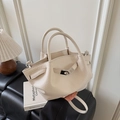 Detail of cream lychee pattern leather handbag with silver lock and elegant pleats - White