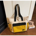 Detail of color-block nylon tote bag showing durable texture and side drawstring pocket - Yellow