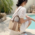 Beige canvas bucket bag with brown leather trim and beaded tassel charm accent - Cream White With Pendant