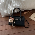 Detail of black crossbody bag with gold medusa buckle and cute teddy bear pendant - With Charm / Black