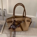 Brown lychee leather bucket bag with contrast handle and cute dog charm ornament - Khaki With Pendant