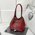 Detail of red bucket bag with woven leather, silver chain drawstring and pearl accents - Red