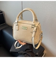 Close-up of cream PU leather box bag with dual handles and gold metal accent - Off-white