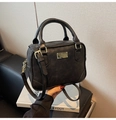 Detail of black faux leather bag with gold hardware and reinforced bottom edges - Black