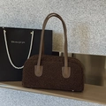 Brown faux shearling underarm bag with leather handles and minimalist rectangle shape - Brown
