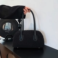 Minimalist black faux shearling shoulder bag with sleek leather handle for women - Black