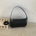 Minimalist black lychee texture barrel bag with silver zipper and adjustable strap - Black