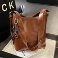Dark brown vintage oil wax leather bucket bag with glossy texture and shoulder strap - Light Brown With Charm