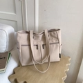 Close-up of cream canvas tote bag with multi-pocket design and wide shoulder straps - Beige Grey