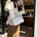 Light blue faux leather crossbody bucket bag with metallic buckle and top handle - Blue