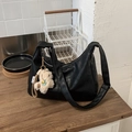 Close-up of soft black leather tote bag featuring a cute white alpaca plush keychain - Black with Pendant