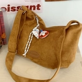Chic warm brown suede tote bag with cartoon charms on a light wood background - With Charm / Brown