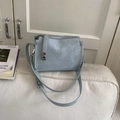 Detail of light blue pillow bag showing natural leather texture and silver hardware accents - Blue