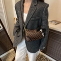 Vintage brown crossbody bag with M-pattern print and chain strap shown on model - Brown