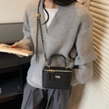 Black mini vanity bag with vertical stripes, gold hardware and chain strap on shoulder - Black