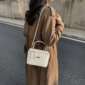 Vintage white woven box bag with gold chain strap and top handle shown on a model - Off-white