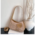 Detail of khaki saddle bag with textured leather, metal eyelets and decorative zippers - Khaki