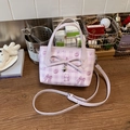 Chic purple plaid bucket bag with bow detail and heart pendant on wooden desk - Purple