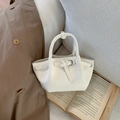 Detail of white bucket bag with lychee texture leather and decorative metal buckle strap - White Without Pendant