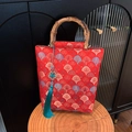 Red jacquard handbag with bamboo handle, fan pattern embroidery and blue tassel charm - Red