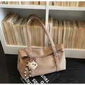 Close-up of brown pebbled leather tote bag with silver rivets and cute bear pendant - Khaki (With Charm)
