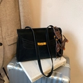 Classic black tote bag with gold swivel lock and decorative charms on a luggage case - Black with Pendant