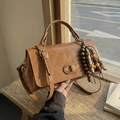 Caramel brown vintage faux leather handbag with golden twist lock and bead charm - With Charm / Brown