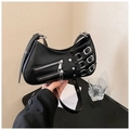 Detail of black glossy leather punk underarm bag with silver buckles and zippers - Black
