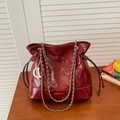 Glossy burgundy bucket bag with quilted patterns and silver metal D pendant - Red